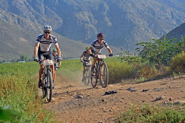 Outcast riders; Team iHUS 2 Kjoren (29-2) Meerendal Centurion Vaude 2 Hermann Pernsteiner (12-1) Team Sellaronda Hero's Sally Bigham (52-1) and Team Bull's Simon Stiebjahn (left rear) during stage 4 of the 2015 Absa Cape Epic. Photo: Dino Lloyd/TreadMTB.co.za