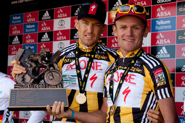 Christoph Sauser and Burry Stander of Team 360ne Songo-Specialized at prize-giving during the final stage (stage 7 ) of the 2011 Absa Cape Epic Mountain Bike stage race held from Oak Valley to Lourensford, South Africa on the3rd April  2011. Photo by Greg Beadle/Cape Epic/SPORTZPICS