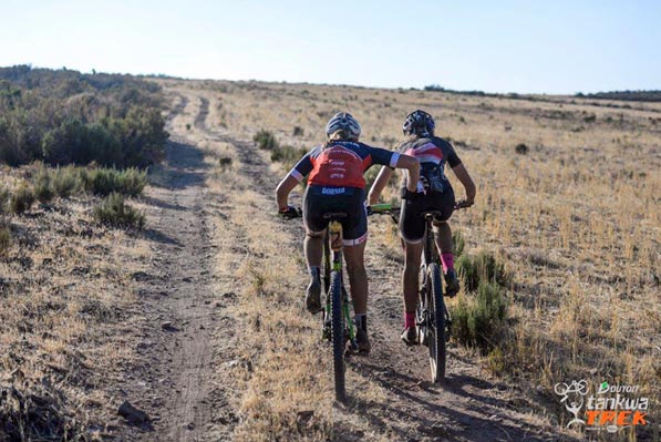 Candice Neethling gives her Spur Dorma teammate, Bianca Haw, a push on their way to second place in the women’s category on Stage 2 of the DUTOIT Tankwa Trek international mountain bike stage race in South Africa on Saturday. Photo: www.zooncronje.com