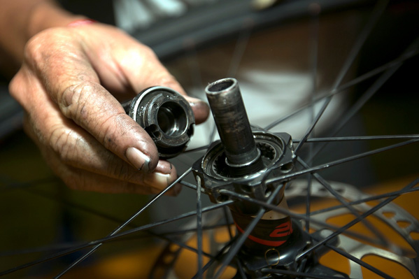 A mechanic services a freehub in the tech zone. Photo: Mark Sampson/Cape Epic/SPORTZPICS