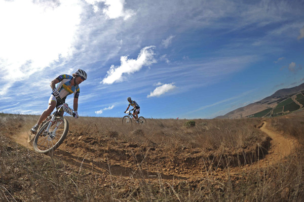 Thomas Frischknecht will be racing in the 2017 Cape Epic in the mixed category, alongside Cross country (XCO) star and Olympic Champion Jenny Rissveds who announced her participation in the event. Pictured here, Thomas Frischknecht and Urs Grieg of Team Rwanda Cycling 2 enjoying the singletrack riding during the Prologue of the 2013 Absa Cape Epic Mountain Bike stage race held at Meerendal Wine Estate in Durbanville outside Cape Town, South Africa. Photo: Kelvin Trautman/Cape Epic/SPORTZPICS