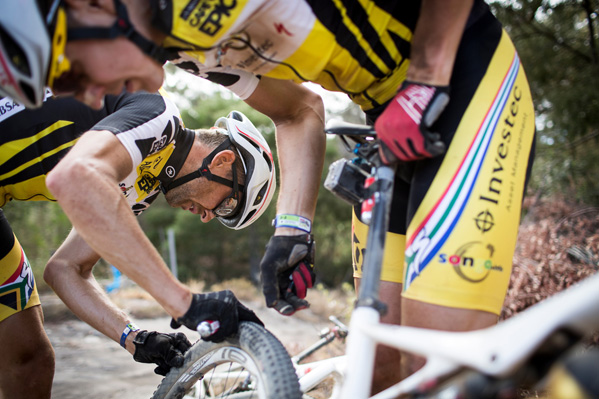 Christoph Sauser checks Jaroslav Kulhavy's wheel for a puncture during stage 3 of the 2015 Absa Cape Epic Mountain Bike stage race held from Oak Valley Wine Estate in Elgin to HTS Drostdy in Worcester, South Africa on the 18 March 2015 Photo: Nick Muzik/Cape Epic/SPORTZPICS