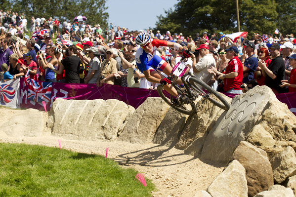 France's Julie Bresset, makes the most of a rock berm on her way to a dominant gold medal performance in the women's race. Photo: Gary Perkin / flipper