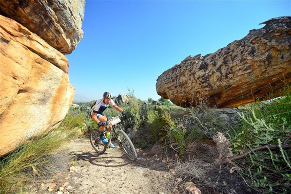 Ancient rock formations of the Kouebokkeveld region create an interesting landscape for competitors at the Momentum Health Tankwa Trek. Here, 2016 winner, Urs Huber, negotiates his way through Stage 1 singletrack. Photo: www.zcmc.co.za